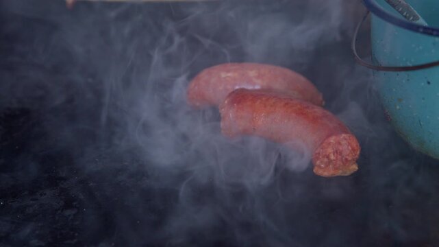 Mexican longaniza sausages cooking on comal