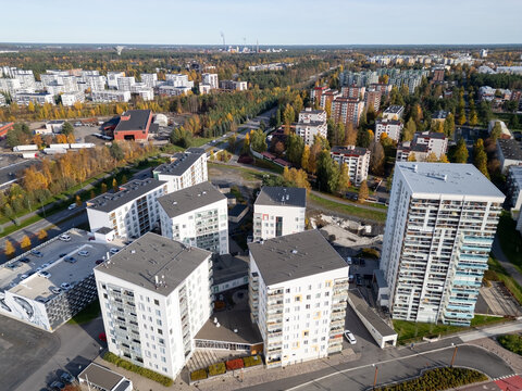 Oulu, Finland - 30 September 2026: Aerial view of Lipporanta residential area featuring modern apartment buildings, parking lots, and surrounding autumn forest landscape.