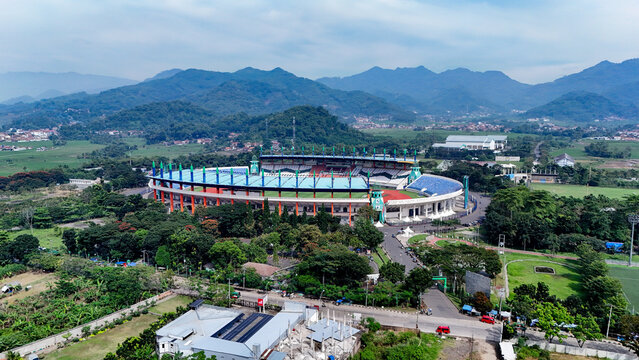Bandung, Indonesia - 12 May 2025: Aerial view of Si Jalak Harupat Stadium surrounded by lush greenery, trees, and mountainous landscape in West Java.