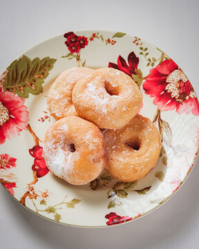 A simple doughnut with tempting powdered sugar.