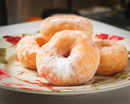 A simple doughnut with tempting powdered sugar.