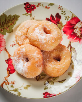 A simple doughnut with tempting powdered sugar.