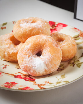 A simple doughnut with tempting powdered sugar.