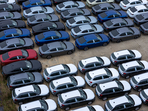 Gdansk, Poland - 03 October 2026: Aerial view of many new Skoda cars parked in an organized lot, showcasing various models and colors under daylight.