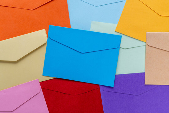 A flat lay of colorful blank paper envelopes. Mail, communication, direct marketing, and correspondence concept.