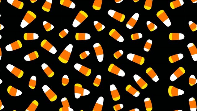 Seamless pattern with colorful candy corn sweets scattered on a black background for halloween celebration