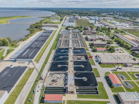 Green Bay, WI, United States - 22 September 2026: Aerial view of the Green Bay Metropolitan Sewerage District, featuring large circular treatment tanks and industrial buildings near the bay.