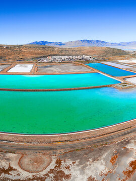 Ogden, Utah, United States - 30 September 2026: Aerial view of the Western Zirconium Inc factory and its vibrant turquoise wastewater evaporation ponds in an arid desert landscape.