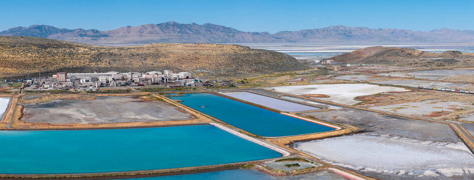 Ogden, United States - 30 September 2026: Aerial view of the Western Zirconium Inc factory and Westinghouse facility, with turquoise wastewater evaporation ponds and arid mountains.