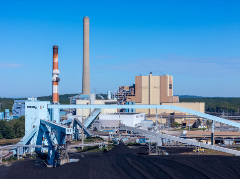 West Olive, Michigan, United States - 28 September 2026: Aerial view of Consumers Energy J.H. Campbell Generating Complex with smokestacks, industrial buildings, and coal piles.