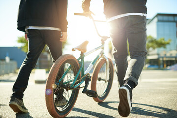 Naklejka premium Bicycle, legs and people for outdoor hobby, activity or challenge in urban park. Bike, shoes and feet for cycling, BMX training and skills for competition in city for walking and stunt exercise
