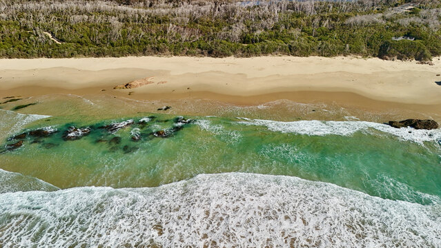 Betka Beach, Mallacoota, Victoria, Australia &ndash; 4K aerial drone view of Betka River Estuary meeting the ocean with golden sand, turquoise water, surf and pristine East Gippsland coastline