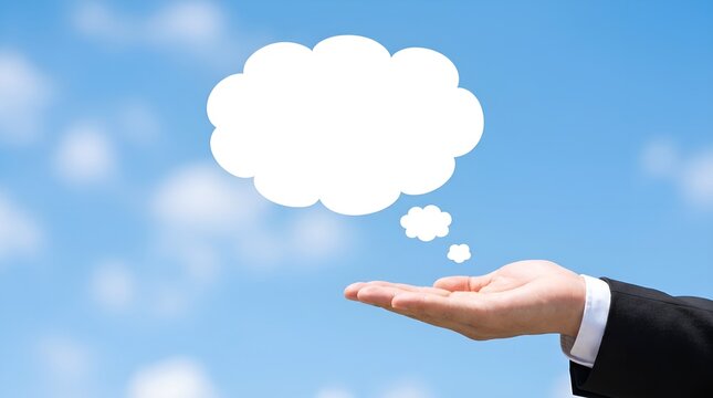 Blank thought bubble graphic above businessman hand, empty speech cloud icon on blue sky background, creative concept copy space for message