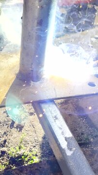 Vertical POV. Electrode with stick welding used to join pieces of steel together