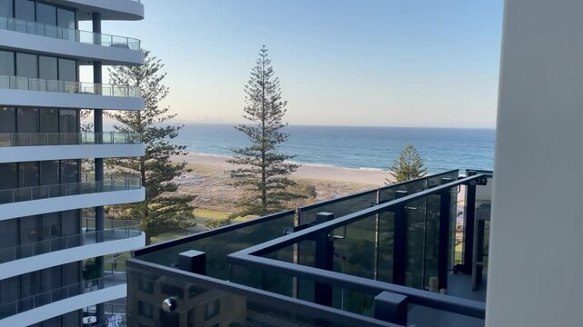 4K video shot filmed from a balcony with a partial ocean view and a beautiful sandy beach in Australia