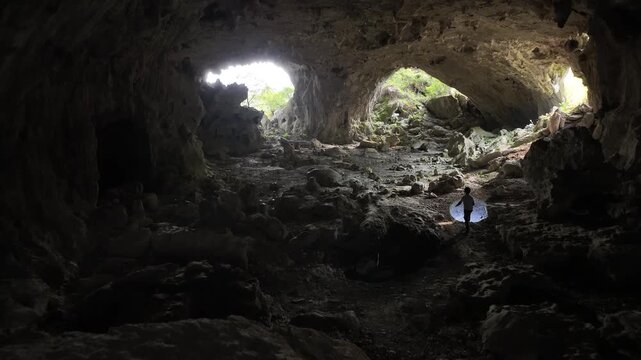 Aerial view of Kong Cave interior with rocky terrain and natural light filtering through the large opening in Guiyang, Guiding, Guizhou, China.