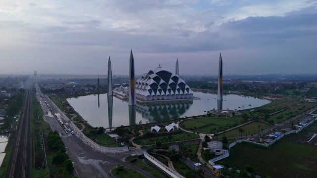 Aerial view of Al Jabbar Grand Mosque featuring its unique geometric architecture and surrounding reflecting pool in Bandung, West Java, Indonesia.