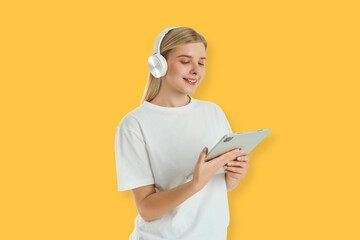 Woman smiles while using tablet and listening to music. Digital entertainment concept © Atlas