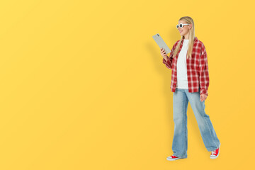Woman walks confidently while browsing on tablet © Atlas