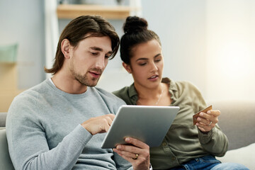 Fototapeta premium Credit card, ecommerce and tablet with couple on sofa in living room of home together. App, checkout payment and online shopping with people in apartment for buying, finance decision or purchase