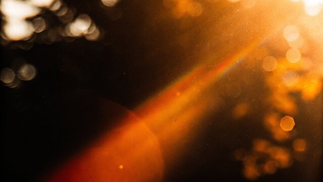 Light leak overlay with blurry bokeh, retro film grain, dust, noise, flare and distressed film burn effects on a black background, ideal for cinematic and creative designs.