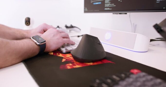 Code writing. Typing keyboard. Male backend expert hand programming software on modern gadget making application script at office desk.