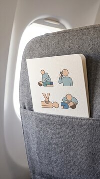 CPR instruction card in pocket of airplane seat