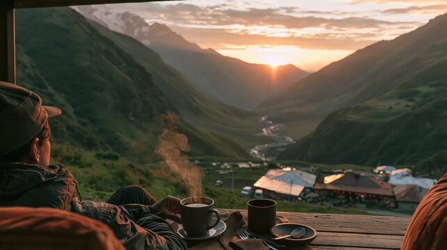 Traveler sitting alone at a roadside cafe overlooking a mountain valley at sunrise, with a clean uncluttered composition