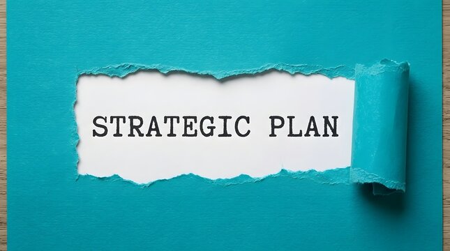A torn turquoise paper revealing the bold black text Strategic Plan printed on a white background, representing business strategy and corporate planning concepts