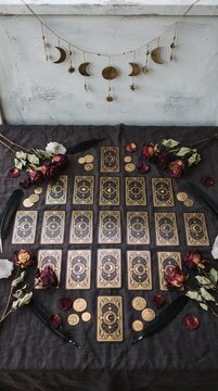 Moon phase garland over tarot cards dried roses and feathers