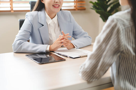 HR manager welcoming new employee with a handshake after successful interview.