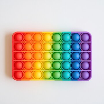 Colorful rainbow silicone fidget toy on white background