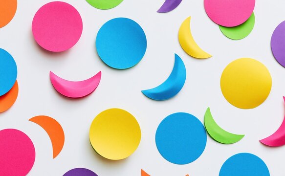 Colorful paper circles and crescent shapes arranged on
