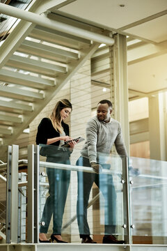 People, tablet and meeting in lobby for business, agenda and feedback for project. Proposal, tech and admin team on office stairs for planning, schedule update and support for company development