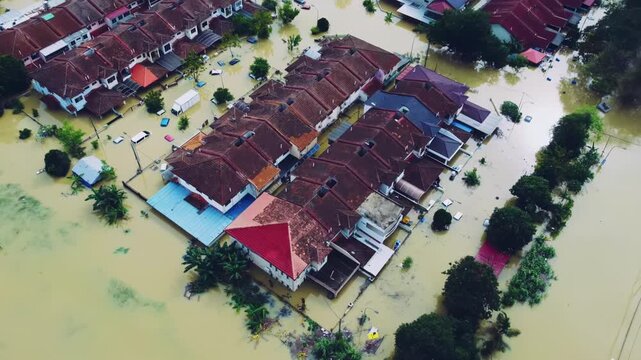 Aerial view of a residential area with houses and cars submerged under water as a result of flooding in Asia.