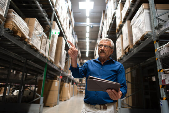 Warehouse manager inspecting inventory shelves.