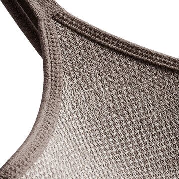 Knit construction detail of sports bra strap meeting the cup on a transparent background