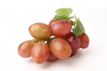 Fototapeta premium Bunch of fresh ripe grapes with green leaves on white background