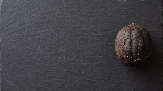 Dried black lime loomi on dark charcoal slate with copy space