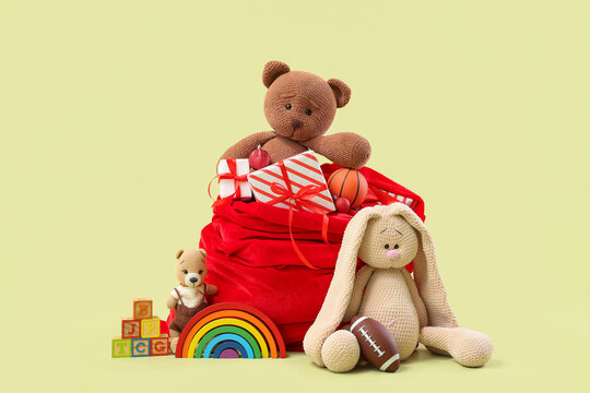 Christmas gift delivery and holiday surprise, Santa Claus red velvet sack filled with toys and presents for children on a soft pastel background