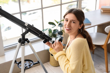 Fototapeta premium Astronomy and scientific discovery, young woman using a telescope at home for stargazing and space exploration with curiosity and passion for science