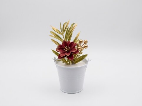 Elegant artificial burgundy flower arrangement with golden leaves in a minimalist white bucket, ideal for holiday greeting card backgrounds, festive interior decor mockups, and winter product staging