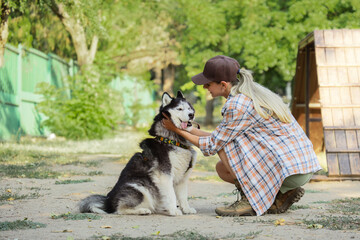 Pet companionship and animal welfare, woman bonding with her husky dog in a park during a sunny day for outdoor recreation and healthy lifestyle © Pixel-Shot