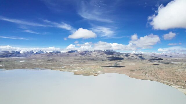 Drone view landscape of Ali in Xizang, snow mountains and lakes with blue sky and white clouds background in sunny day in Tibet, China, 4k real time footage b roll travel concept