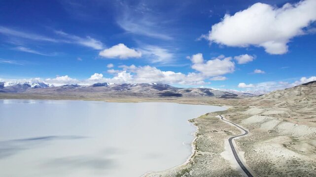 Drone view landscape of Ali in Xizang, snow mountains and lakes with blue sky and white clouds background in sunny day in Tibet, China, 4k real time footage b roll travel concept