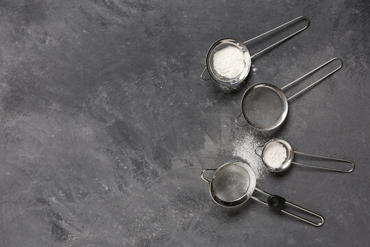 Baking and culinary preparation, flour sifting with metal strainers on dark stone background for food blog and recipe content