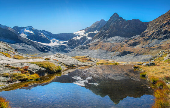 glacier and  lake  in french alpine mountains under a blue sky in autumn, the Vanoise park, Savoie