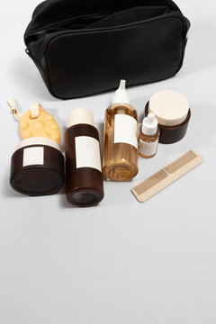 Aesthetic arrangement of skincare ritual with clean oil pump bottle, creame jars, toner lotion, serum, solid shampoo, sea sponge and hair comb