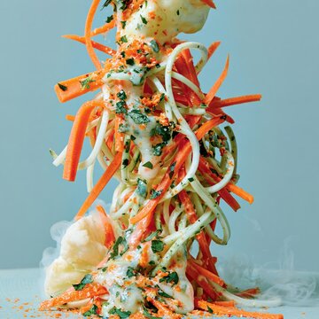 Artistic tower of julienne carrots and zucchini with cauliflower