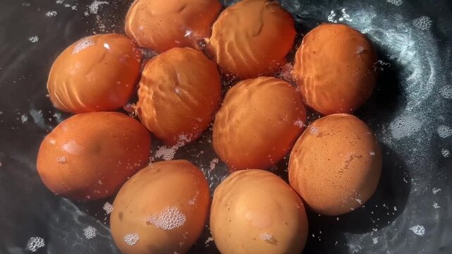 Close up hard-boiled eggs in hot, bubbling water. A simple egg-boiling. 